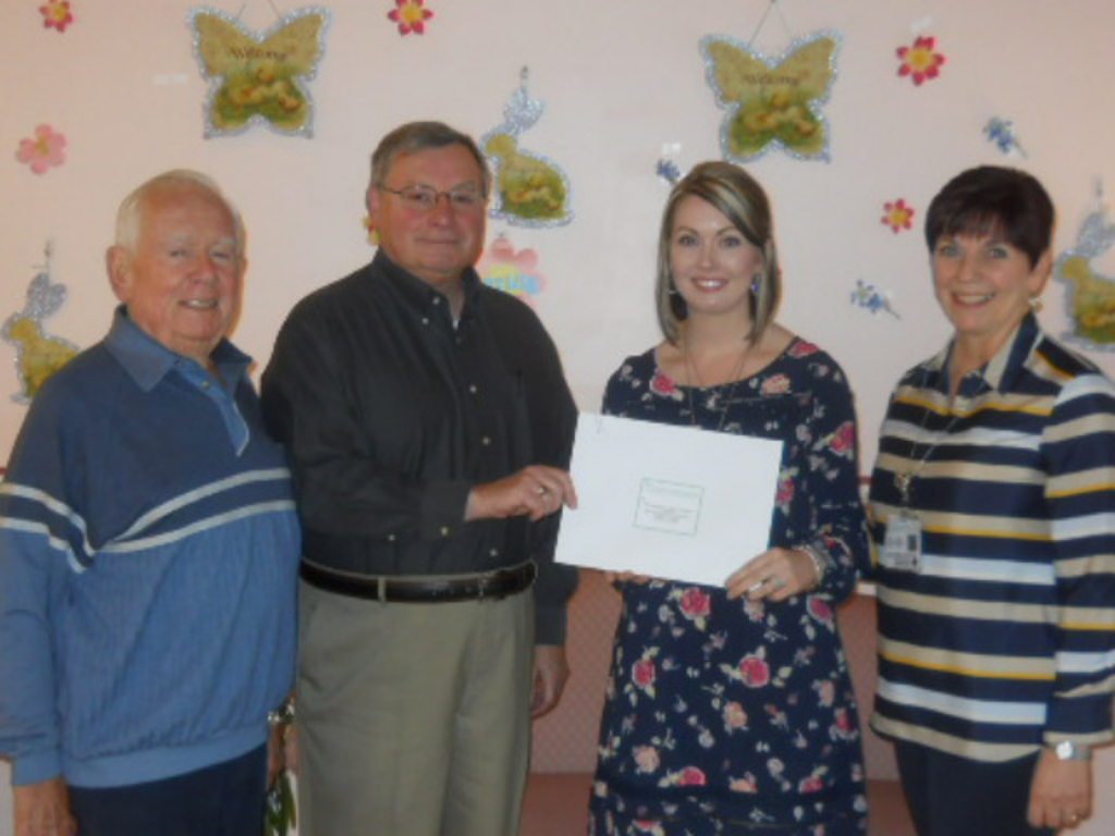 Don Fleming and Bob Ordiway present a check to Megan Bolden, administrator at Pinecrest Manor, and Rose Campbell, president of Penn Highlands Elk.